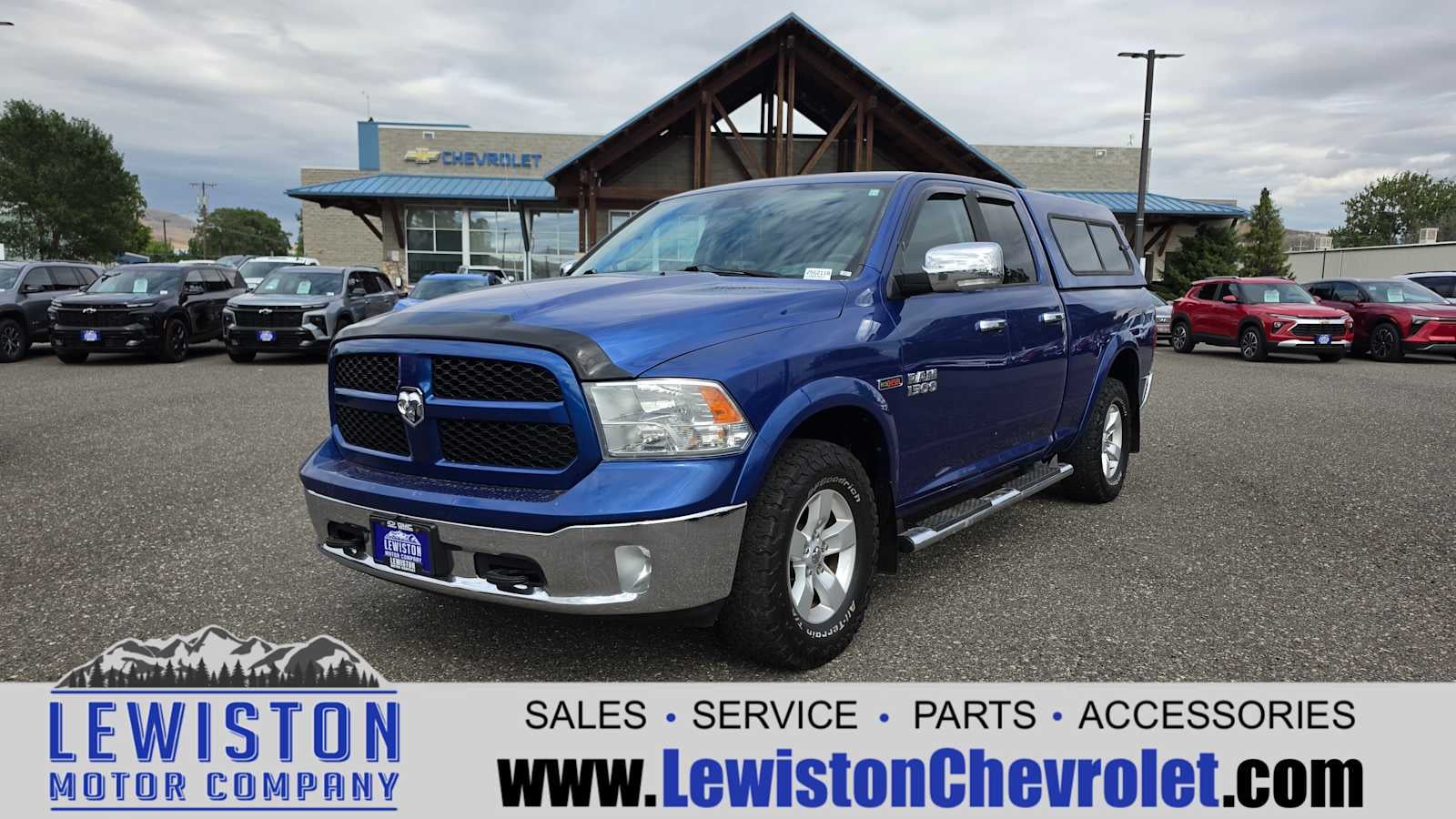2014 RAM 1500 Outdoorsman in True Blue Pearlcoat — front three-quarter view