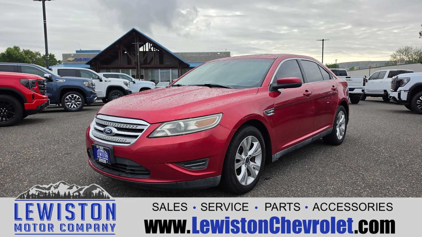 2011 Ford Taurus SEL in Red — front three-quarter view